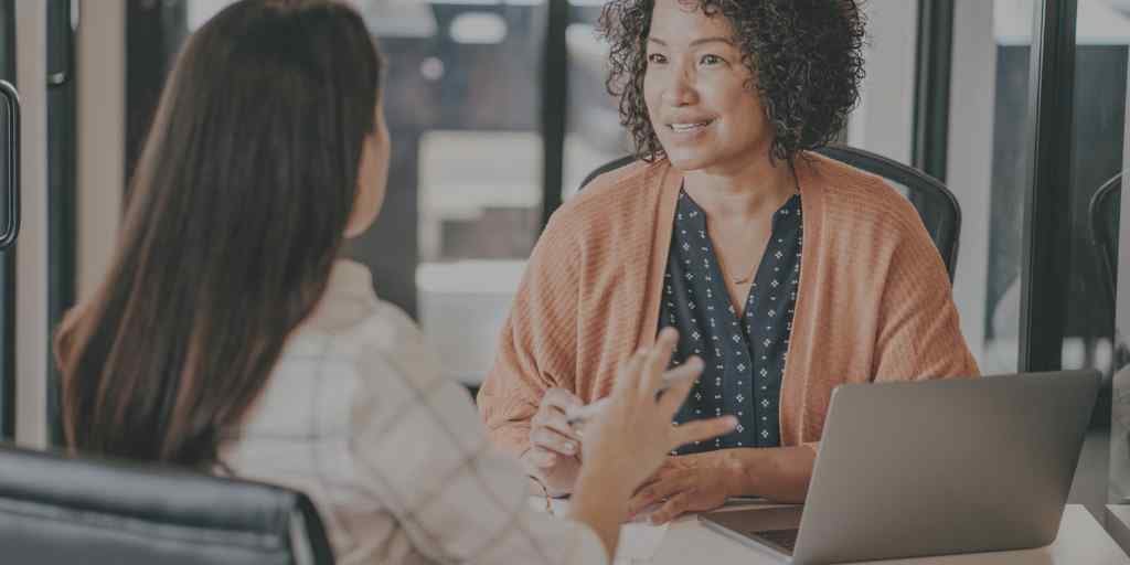 two women meeting in office setting