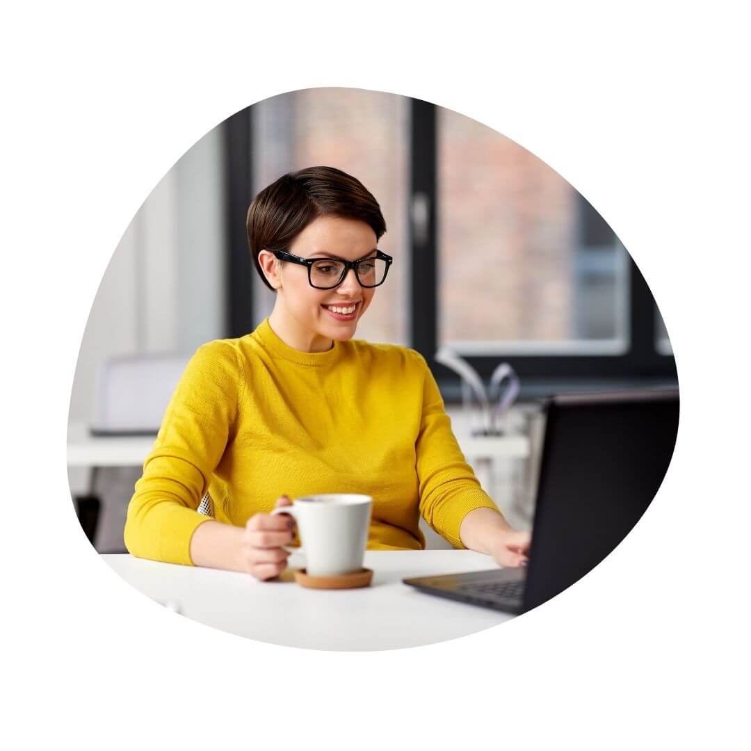 woman at laptop with coffee cup