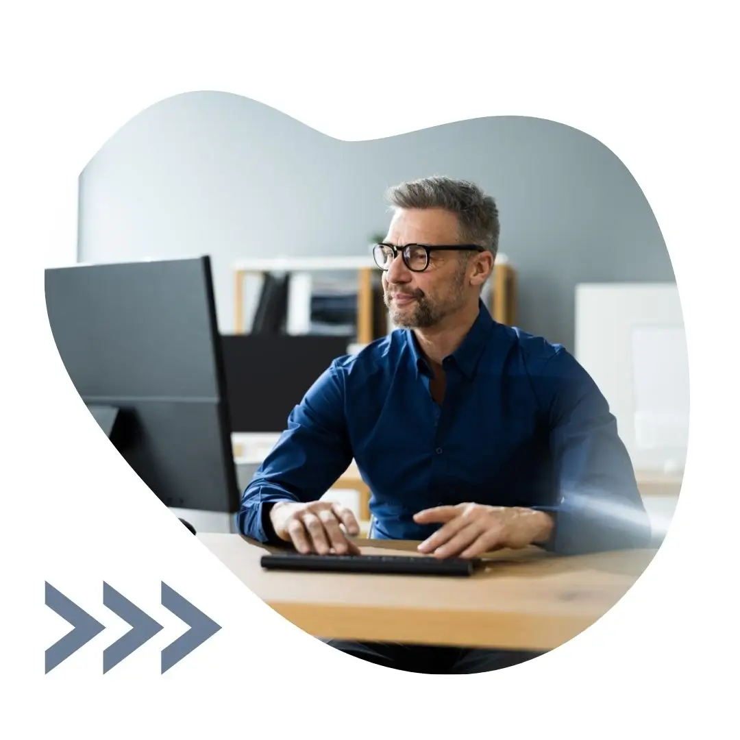 Man at desk using computer in office setting photo image