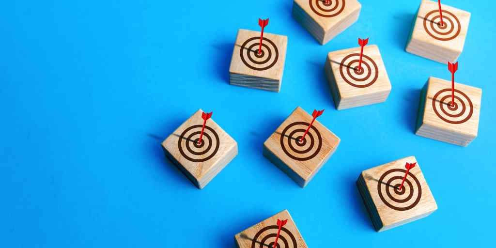 Many small squares made of wood with target and bullseye and arrow on each
